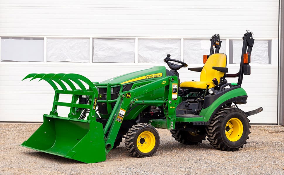 green tractor with grapple